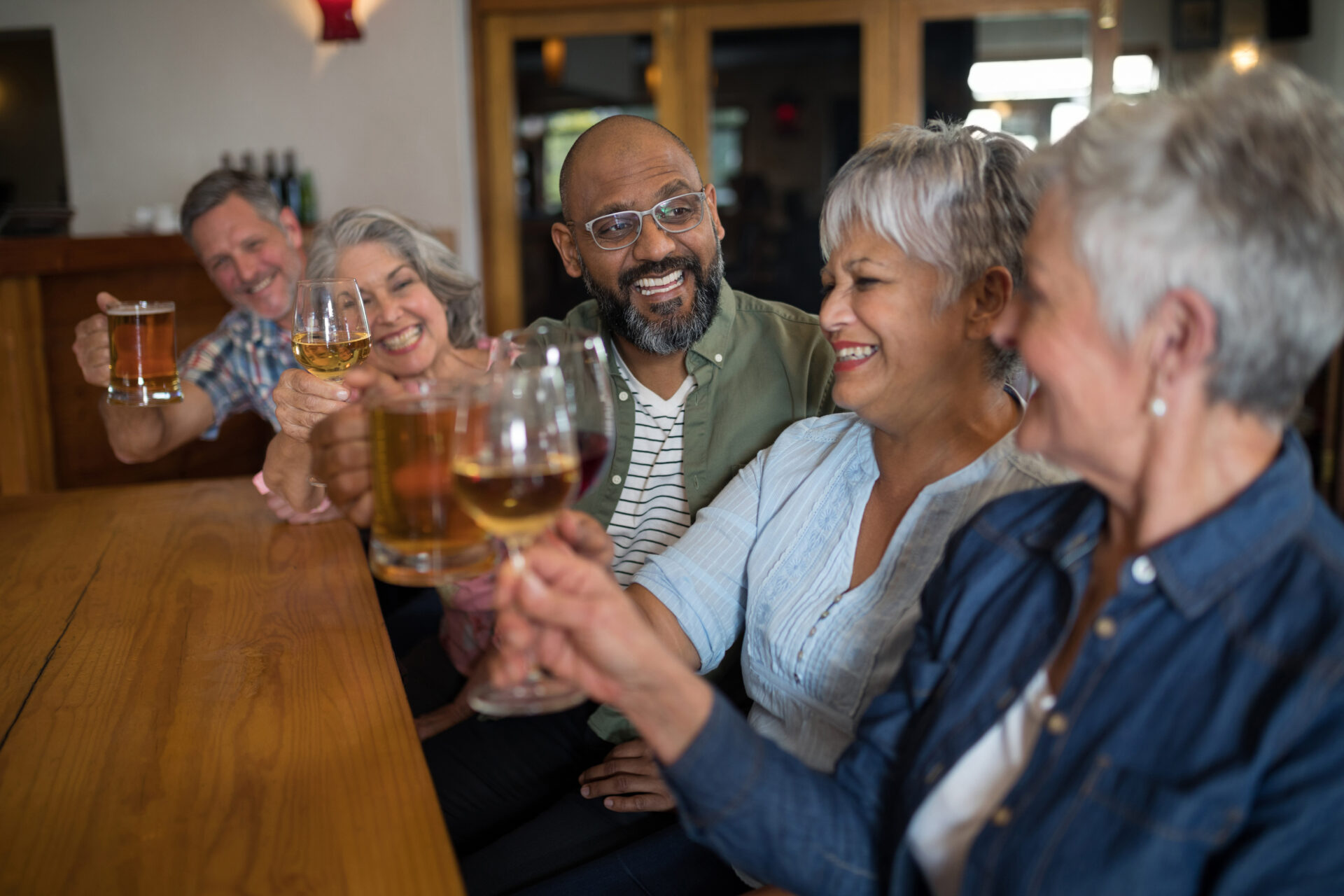 Seniors drinking liquor at table